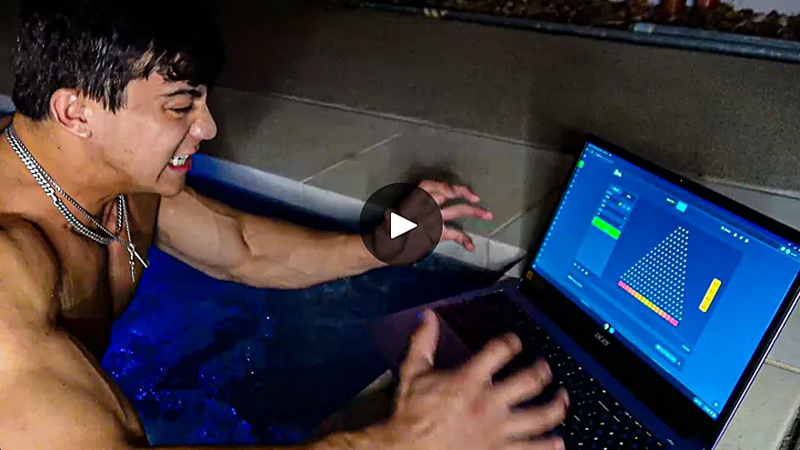Togi in an ice bath playing Plinko on a laptop